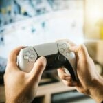 person holding black game controller