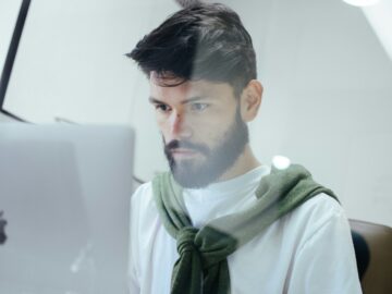 man facing MacBook Pro