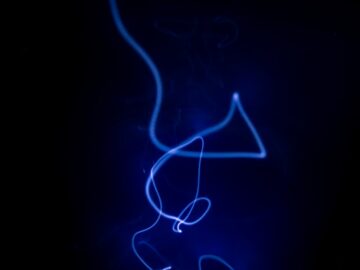 a blue light is shining on a black background