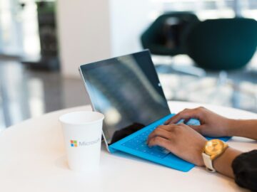 person using blue Microsoft Surface
