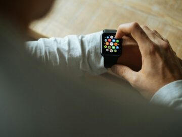 person holding Apple Watch with black Sport Band
