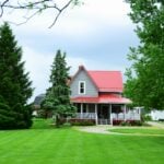 a house with a red roof surrounded by trees