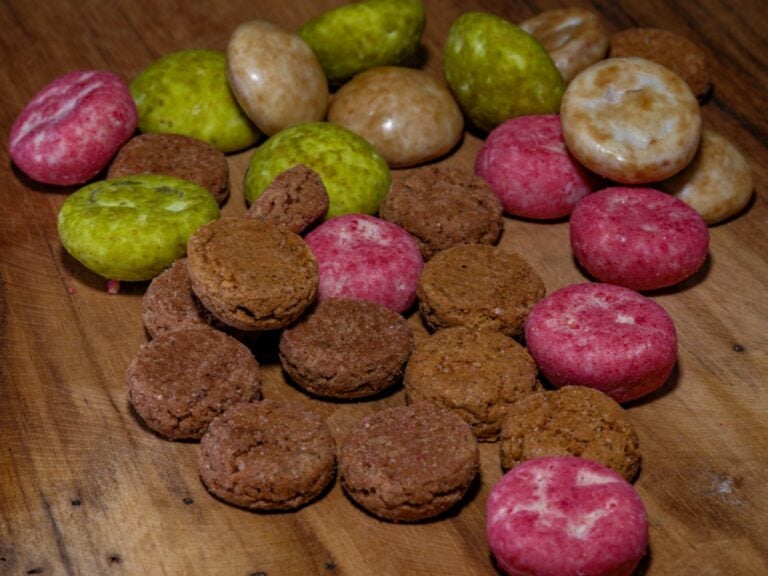 A wooden table topped with different types of cookies