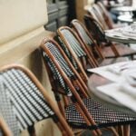 Outdoor cafe chairs and tables await diners.