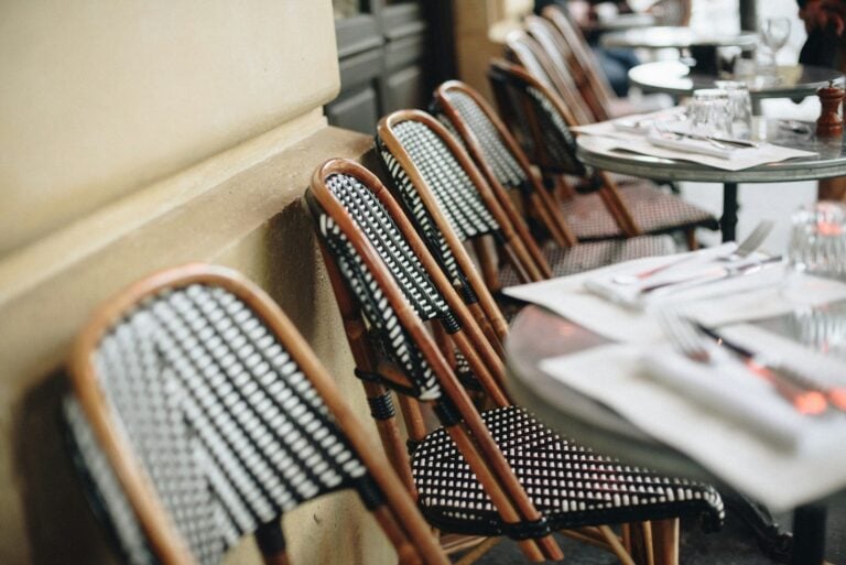 Outdoor cafe chairs and tables await diners.