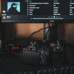 black canon dslr camera on black computer keyboard