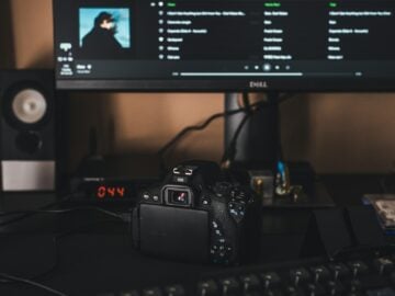 black canon dslr camera on black computer keyboard