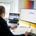 a man sitting at a desk using a computer