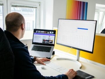 a man sitting at a desk using a computer