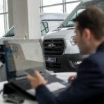 A man sitting in front of a laptop computer