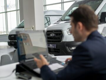 A man sitting in front of a laptop computer