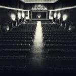 Empty vintage cinema hall with a screen.