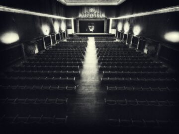 Empty vintage cinema hall with a screen.