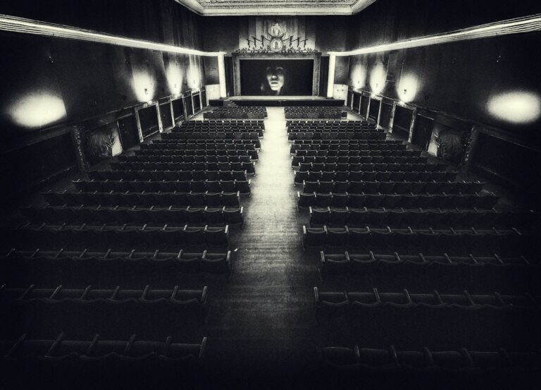 Empty vintage cinema hall with a screen.