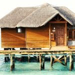 a wooden dock in front of a house