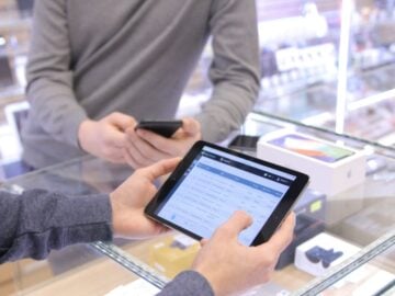 two people are looking at a tablet in a store