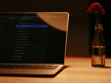macbook pro on brown wooden table