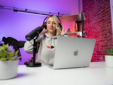 a woman sitting in front of a laptop computer