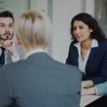 Business people in a meeting around a table.