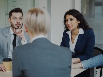 Business people in a meeting around a table.