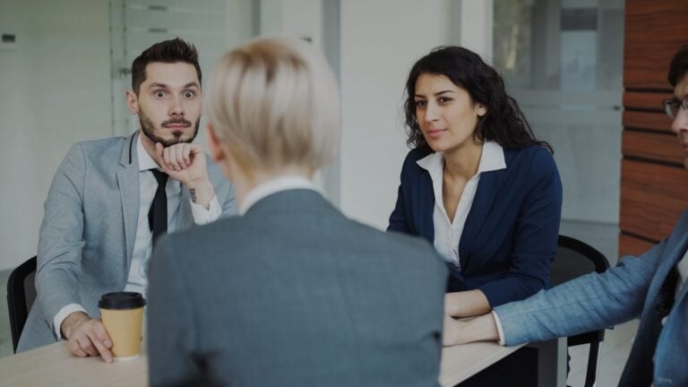 Business people in a meeting around a table.