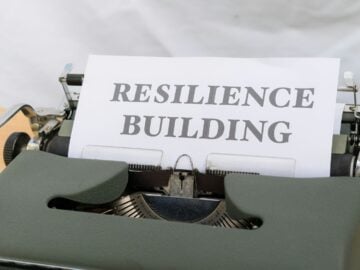 a typewriter with a sign that reads resilince building