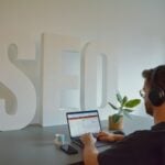 a man sitting in front of a laptop computer
