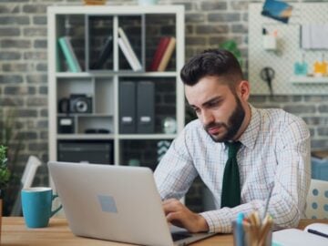 a man sitting in front of a laptop computer