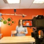 black video camera on brown wooden table