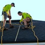 a couple of people that are on a roof