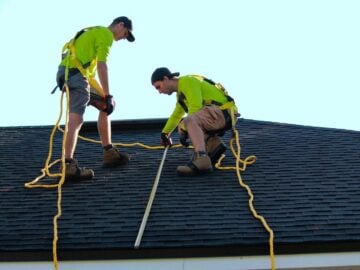 a couple of people that are on a roof